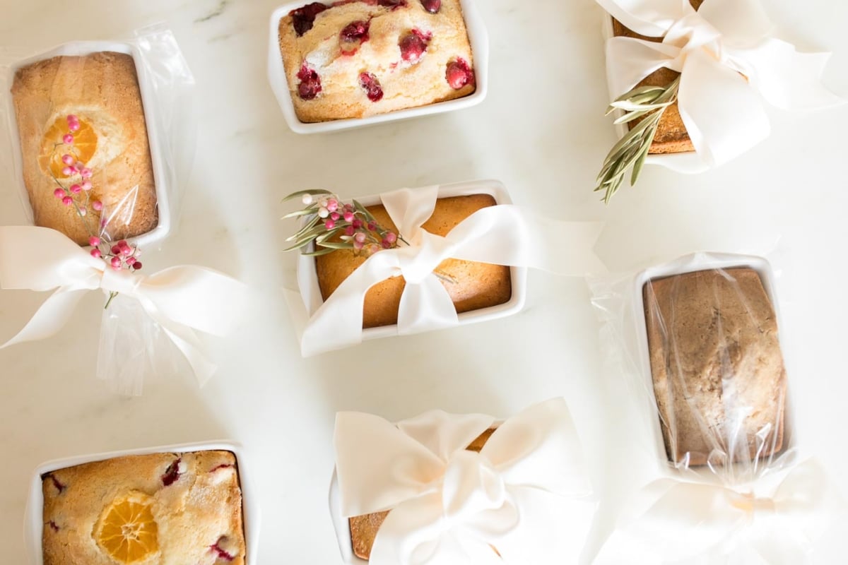 A variety of breads with bows and ribbons on a table.